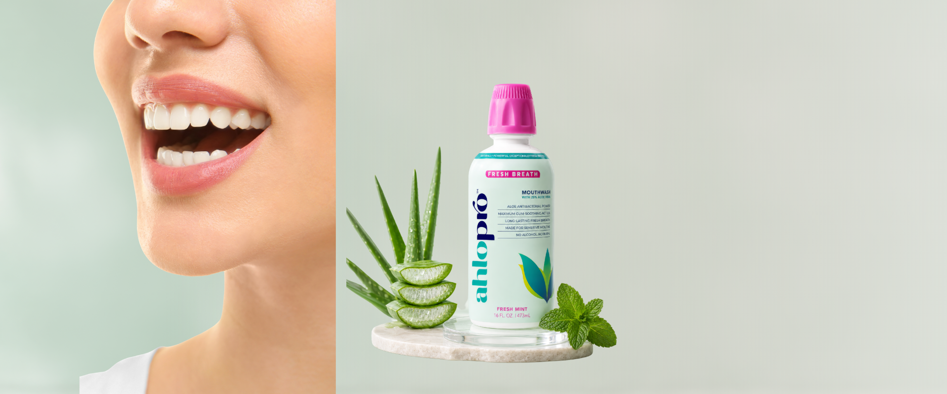 Bottle of aloe pro product with aloe vera plant and mint leaves on a light gray background