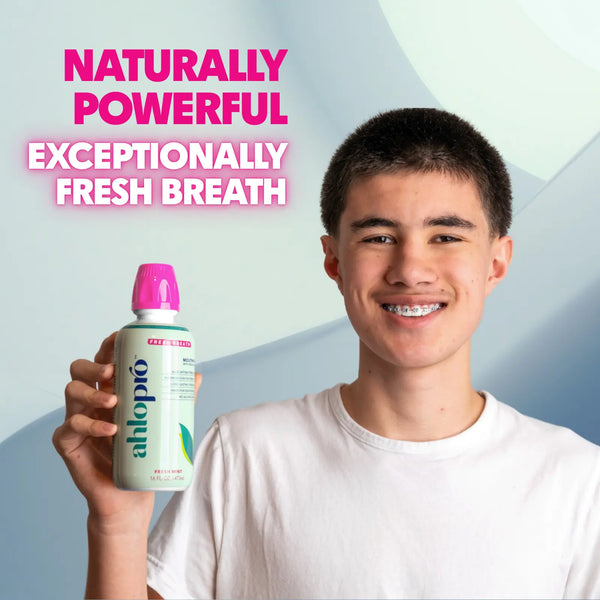 Person holding a bottle of AHLOPRO with text about fresh breath on a gradient background