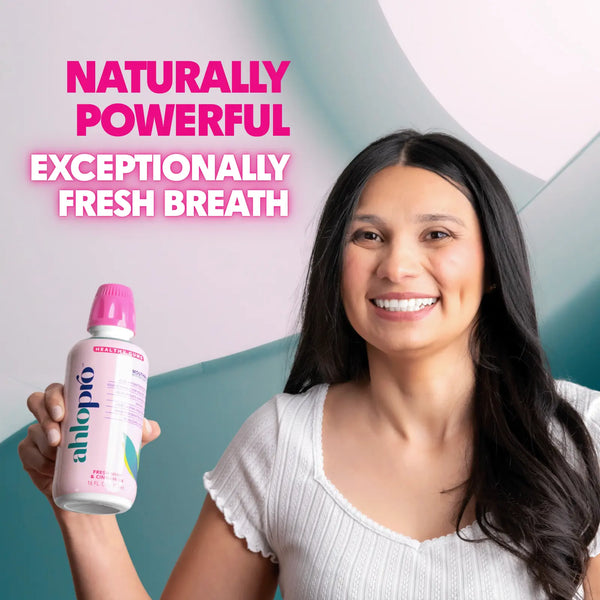 Woman holding a bottle of Ahlo Pro with text about fresh breath on a gradient background