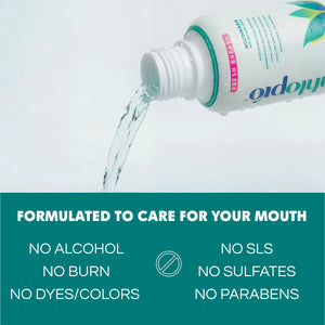 Bottle of mouthwash being poured with text highlighting benefits on a light blue background